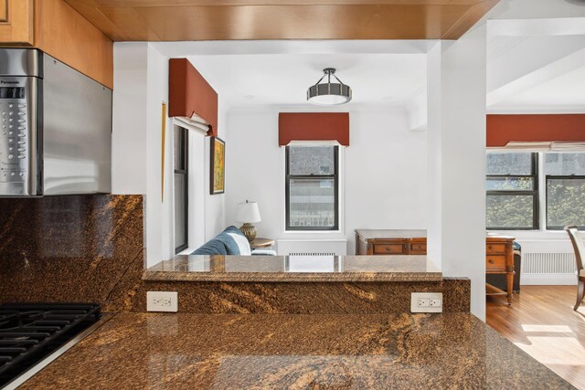 dining area featuring baseboards and hardwood / wood-style floors