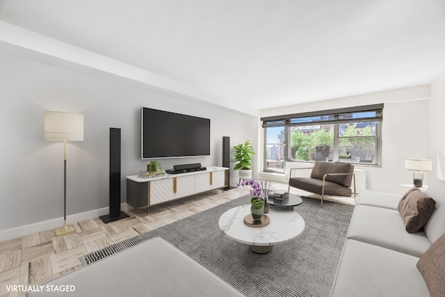 living area featuring baseboards