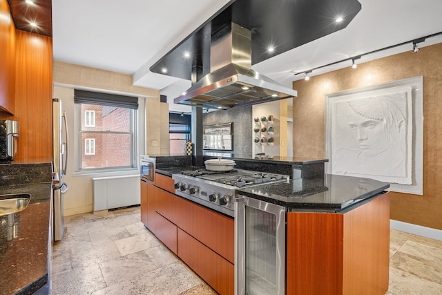 75 E End Ave Unit 19C, New York City, NY 10028 - kitchen featuring island range hood, track lighting, beverage cooler, baseboards, and stone tile flooring