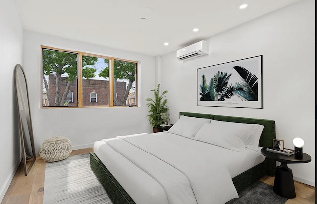 bedroom featuring a wall mounted AC, wood finished floors, recessed lighting, and baseboards