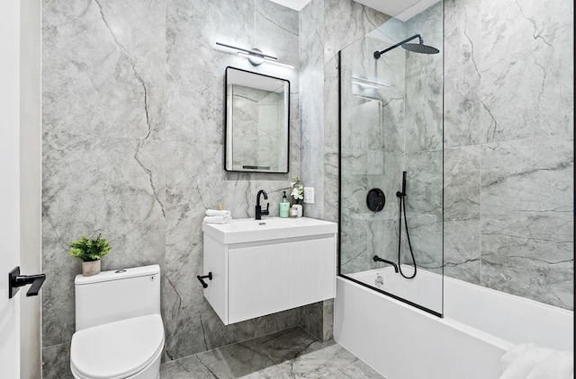 full bathroom with vanity, toilet, washtub / shower combination, and marble finish floor