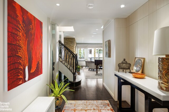 stairway featuring ornamental molding, recessed lighting, and wood finished floors