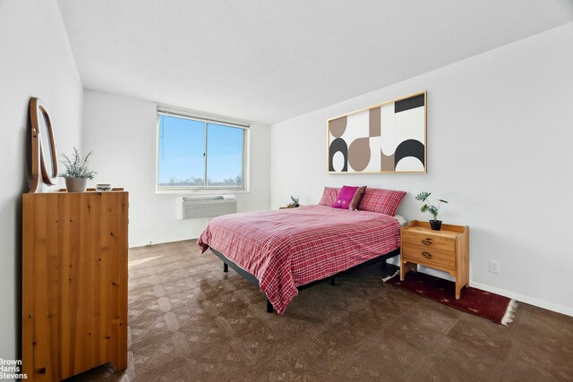 bedroom featuring tile patterned floors, baseboards, and a wall mounted AC