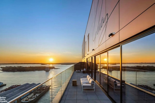 view of dock with a water view and a balcony