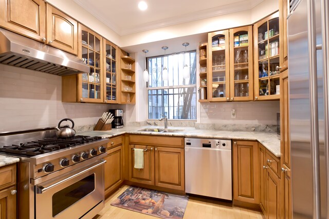 311 W 97th St Unit 2W, New York City, NY 10025 - kitchen with light stone countertops, under cabinet range hood, a sink, stainless steel appliances, and backsplash