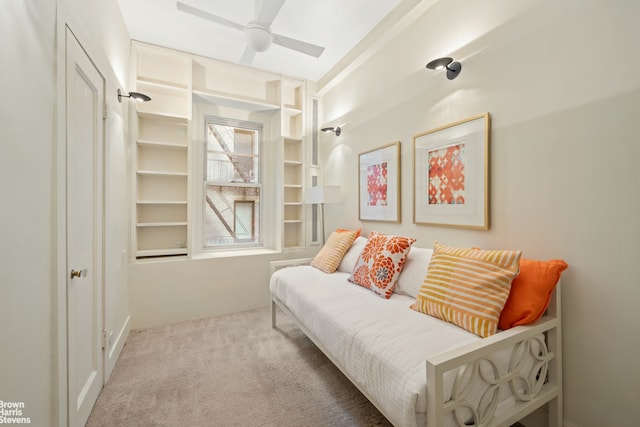 living area with carpet and ceiling fan