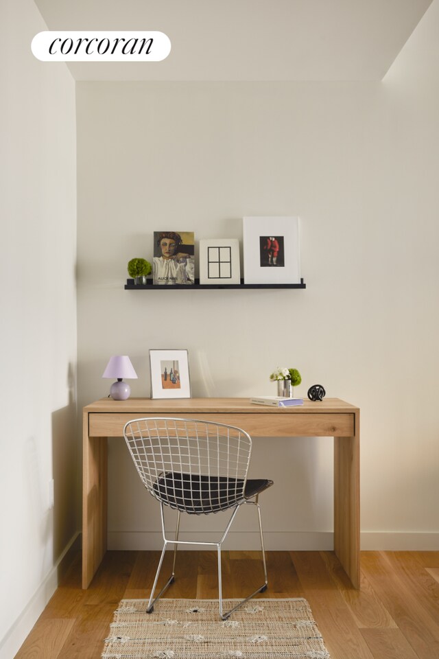 interior details featuring baseboards and wood finished floors