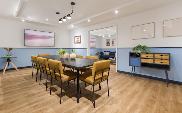 dining area featuring light wood-style floors and baseboards