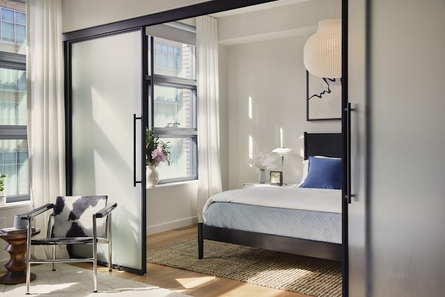 bedroom featuring wood finished floors and baseboards