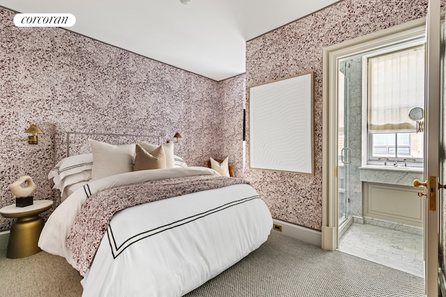 bedroom featuring baseboards, visible vents, ensuite bathroom, and wallpapered walls