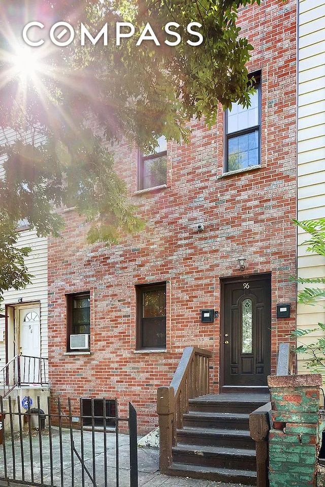 doorway to property with brick siding