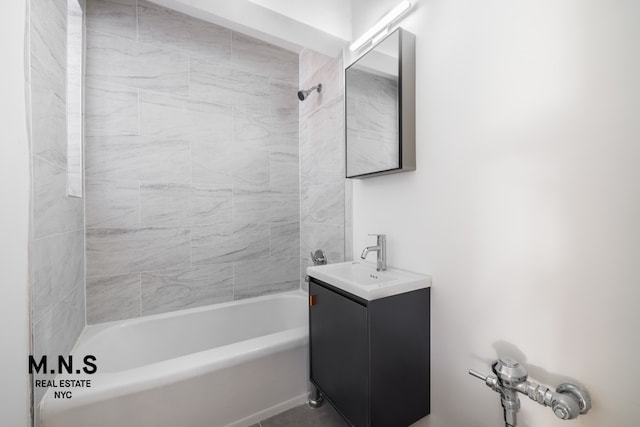 bathroom featuring  shower combination and vanity