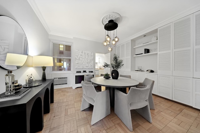 dining area featuring ornamental molding, a chandelier, and an AC wall unit