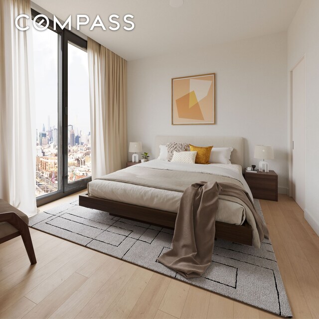 bedroom with access to outside, wood finished floors, and floor to ceiling windows