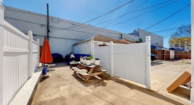 view of patio / terrace with a storage shed, an outdoor structure, and a fenced backyard