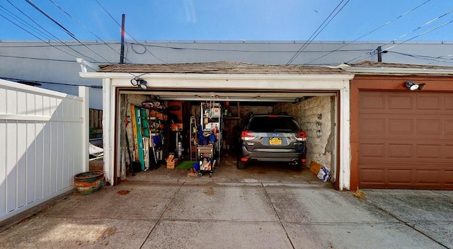 detached garage featuring fence