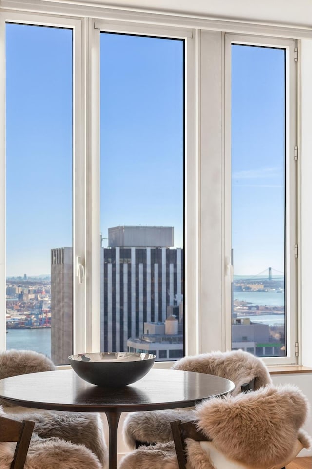 dining room featuring a water view and a view of city