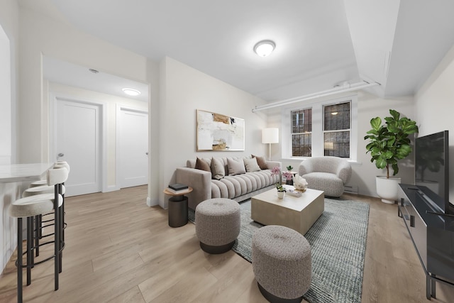 living room featuring light wood-style flooring and baseboards