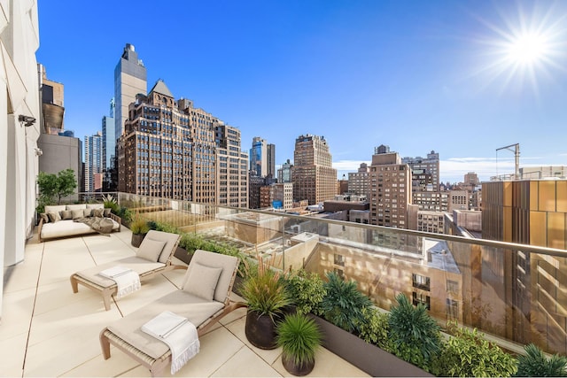 view of patio / terrace featuring a view of city and a balcony