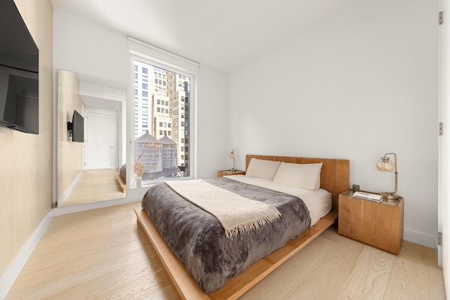 215 W 28th St Unit 14C, New York City, NY 10001 - bedroom featuring wood finished floors and baseboards