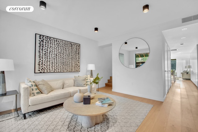 24 Huntington St, New York City, NY 11231 - living area featuring light wood-type flooring, stairs, and recessed lighting