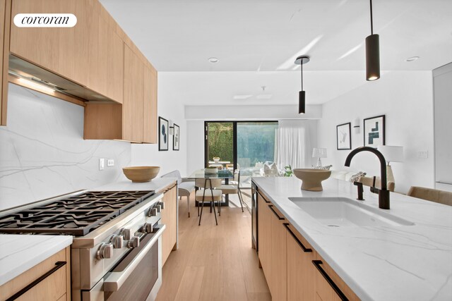 24 Huntington St, New York City, NY 11231 - kitchen featuring high end stainless steel range, light brown cabinets, light stone countertops, and modern cabinets