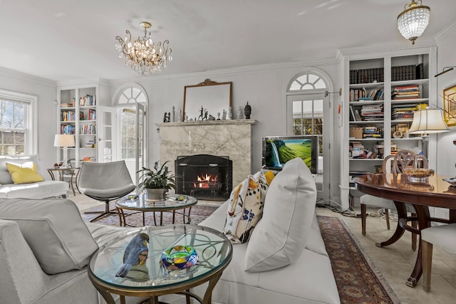 tiled living area with built in features, an inviting chandelier, a fireplace, and crown molding