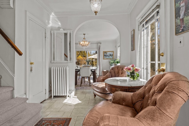 living room with ornamental molding, stairway, arched walkways, radiator, and an inviting chandelier