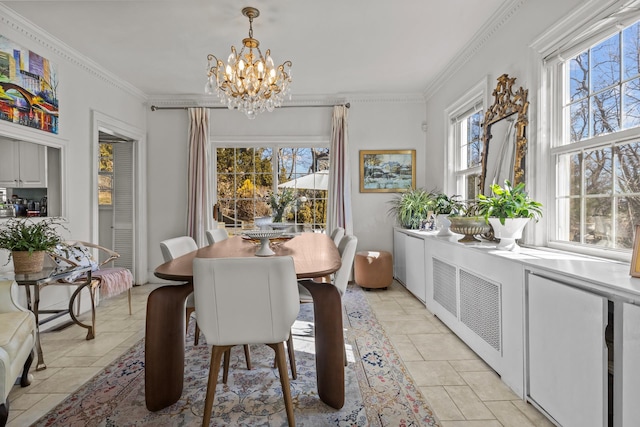 dining room with a wealth of natural light, a chandelier, and crown molding