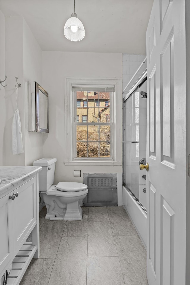 full bath with vanity, toilet, and enclosed tub / shower combo