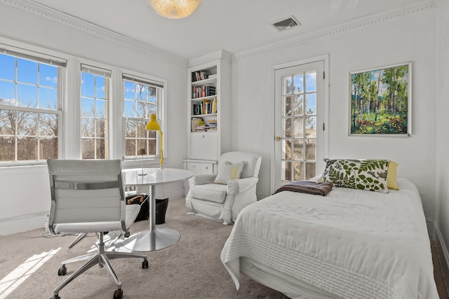 bedroom with visible vents, ornamental molding, and carpet flooring