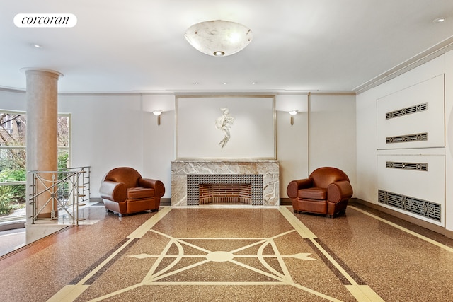 sitting room with speckled floor, visible vents, a fireplace, ornamental molding, and an upstairs landing