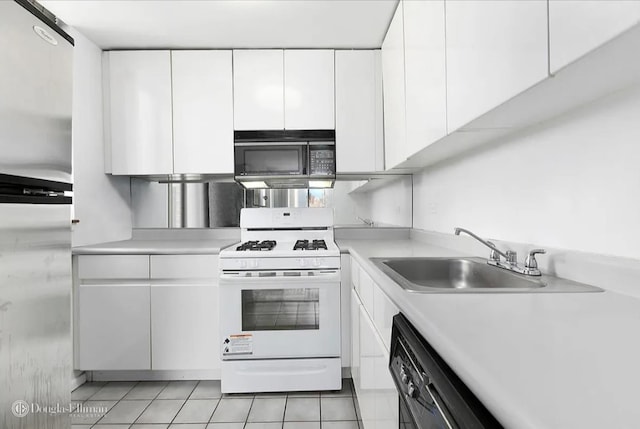 kitchen with white cabinetry, black appliances, light countertops, and a sink