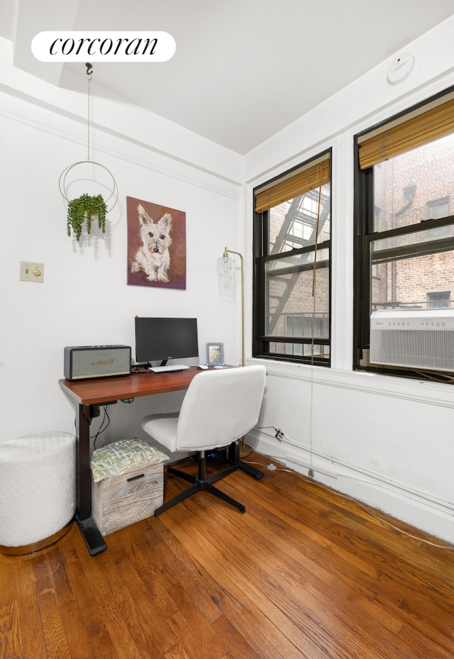 office space with cooling unit and wood-type flooring