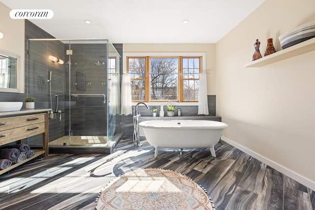 bathroom featuring visible vents, a freestanding bath, a shower stall, and vanity