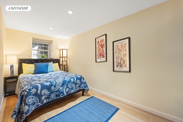 bedroom with recessed lighting, wood finished floors, visible vents, and baseboards