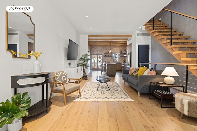 living room featuring wood-type flooring, stairs, visible vents, and recessed lighting