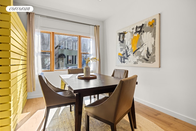 dining room with light wood-type flooring and baseboards