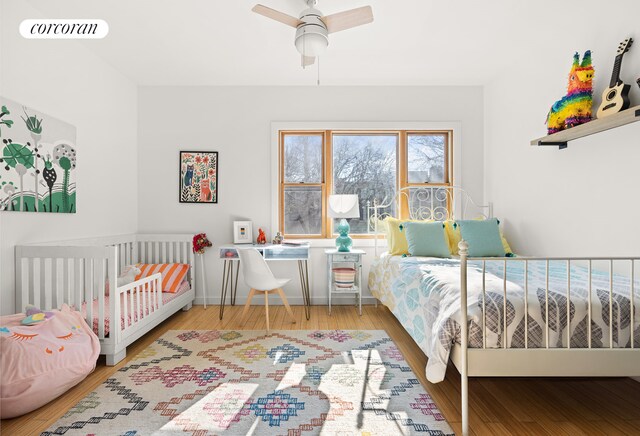 bedroom featuring a ceiling fan, visible vents, and wood finished floors