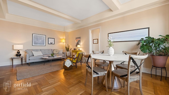 dining room with baseboards and beam ceiling