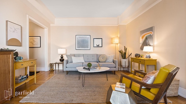 living room with baseboards and wood finished floors