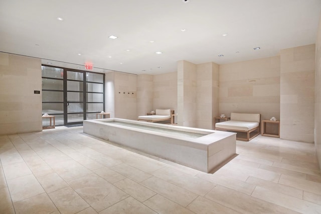 full bath with a bath, tile patterned flooring, recessed lighting, and floor to ceiling windows