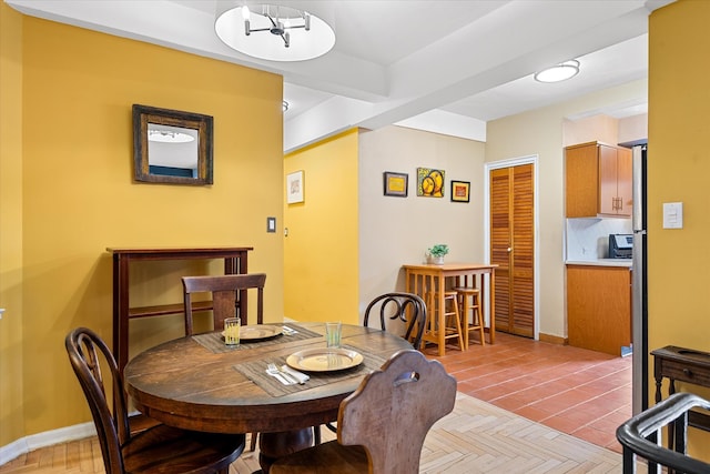 dining room featuring baseboards and a notable chandelier