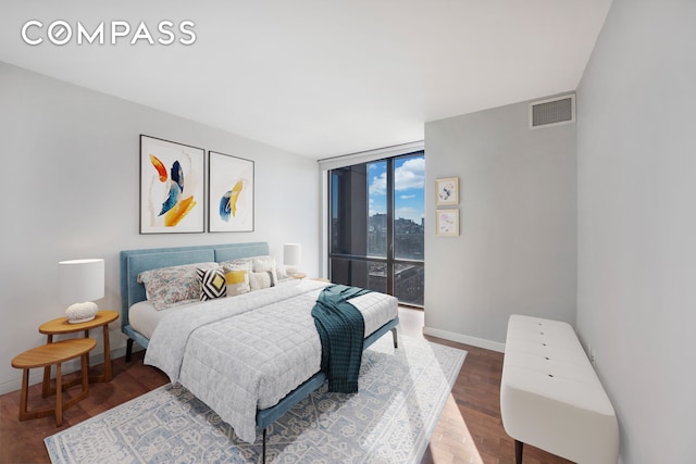 101 W 24th St Unit 19B, New York City, NY 10011 - bedroom with access to outside, wood finished floors, baseboards, and a wall of windows