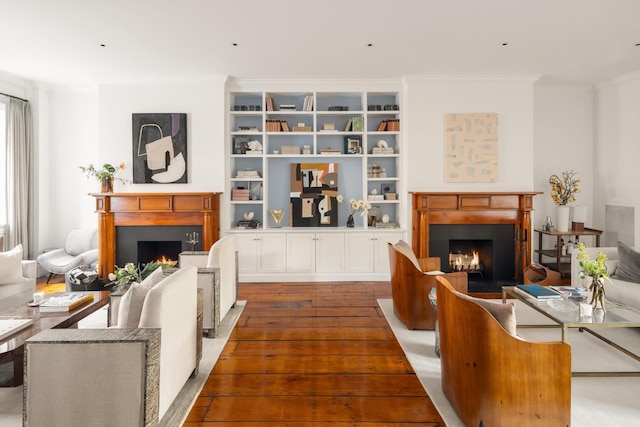 living room featuring crown molding, a lit fireplace, and dark wood-style flooring