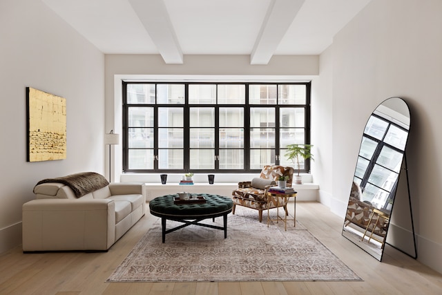 living room featuring beam ceiling and wood finished floors