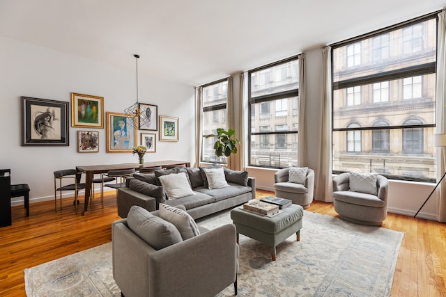 living room with baseboards and light wood-style flooring