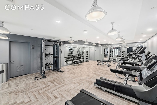 exercise room with visible vents and recessed lighting