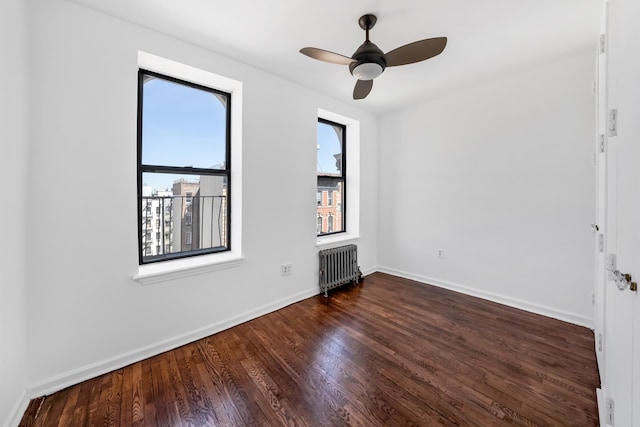 185 E 2nd St Unit 5A, New York City, NY 10009 - unfurnished room featuring radiator, wood finished floors, a ceiling fan, and baseboards