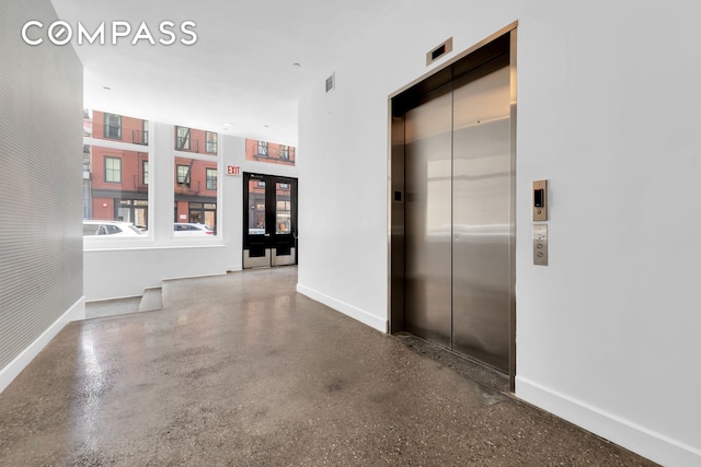 corridor featuring visible vents, elevator, french doors, and baseboards